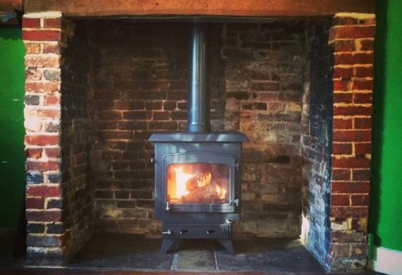 log burner installed into brick fire place