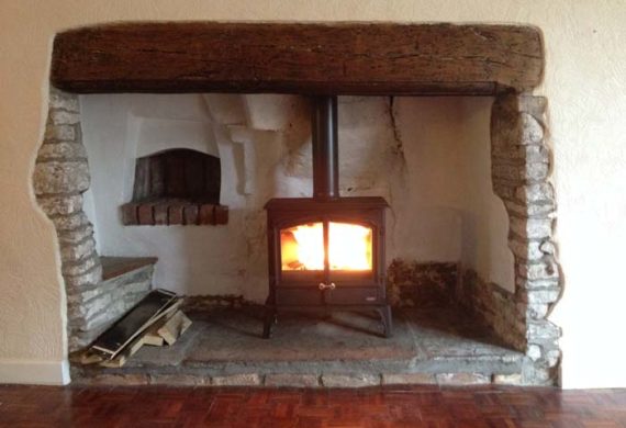 stove installed into a large fire place