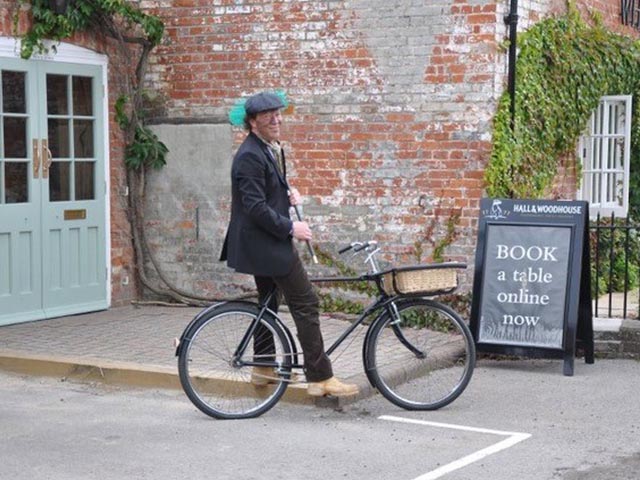 chimney sweep maintenance man on bicycle