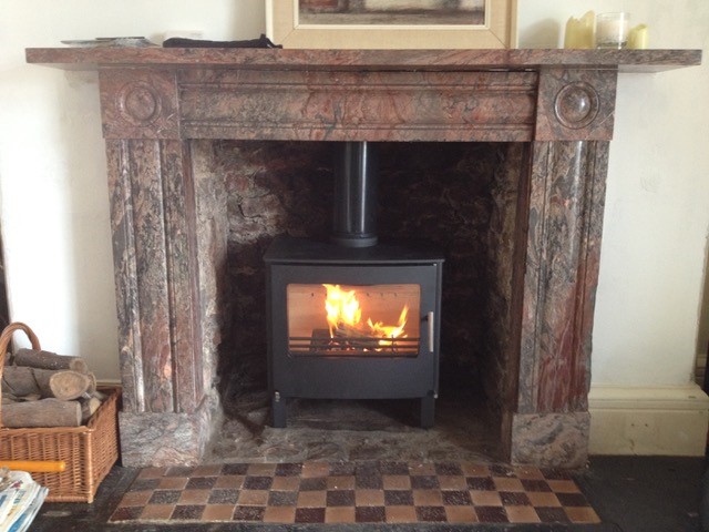 wood burner installed into a brick fire place